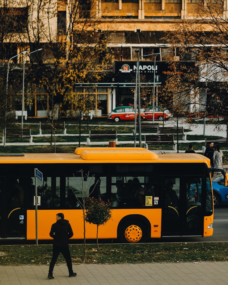 
A Man Walking Towards A Bus