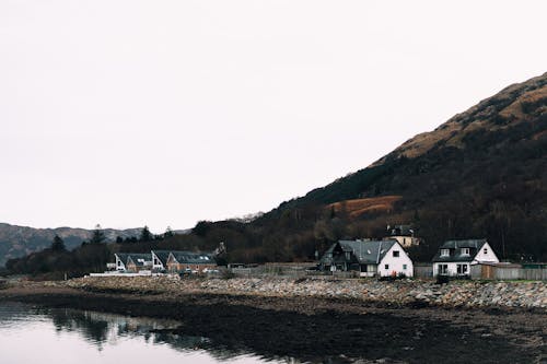 Houses near Lake and Mountain
