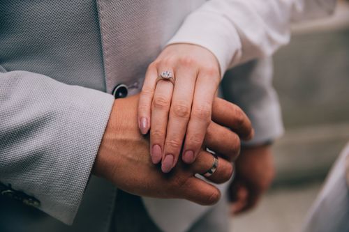 Free Intimate close-up of a couple's hands showcasing wedding rings, symbolizing love and commitment. Stock Photo