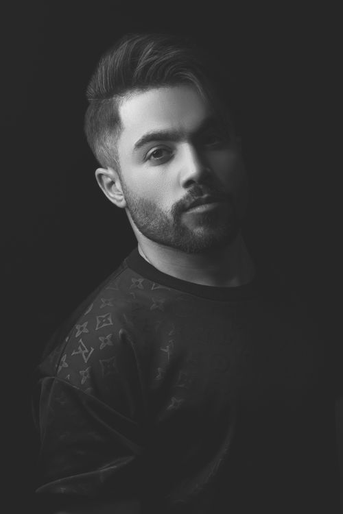 Free Elegant black and white portrait of a bearded man wearing a patterned shirt, captured in Hamedan, Iran. Stock Photo