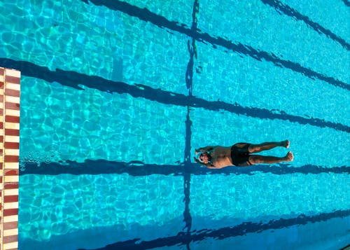 Person Diving on Swimming Pool