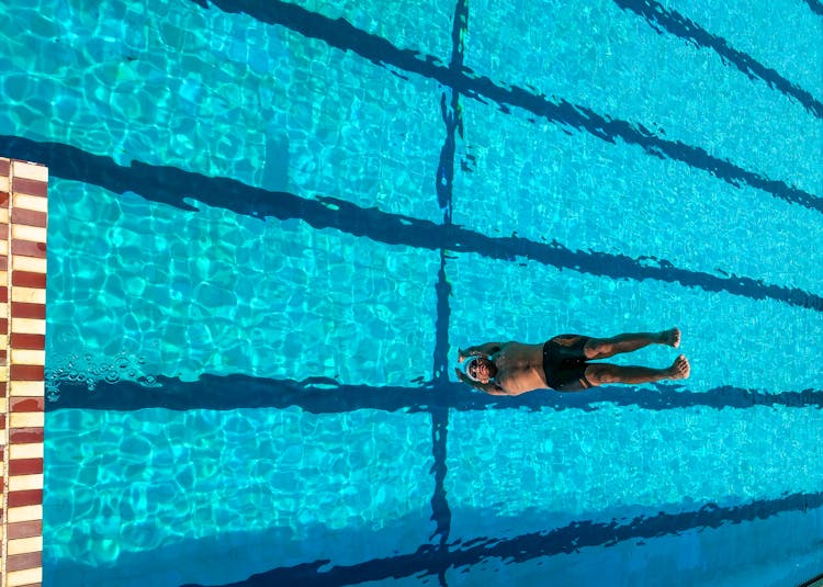 Person Diving On Swimming Pool