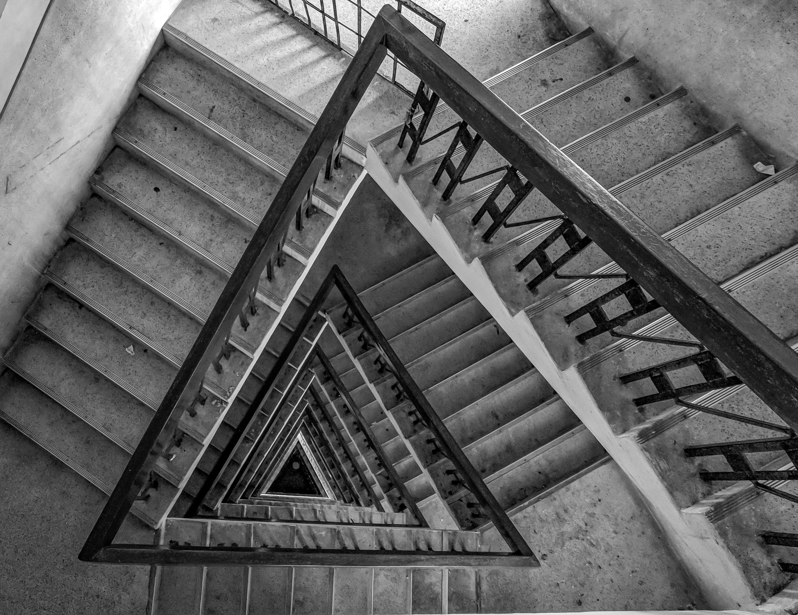 multi floor stairs grayscale photo