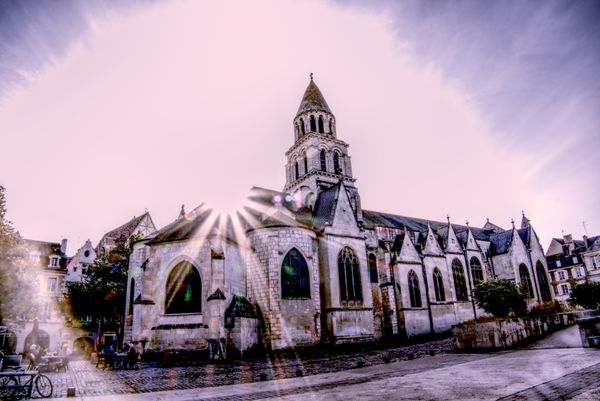 Église gothique Notre-Dame avec un éclat de soleil sur une place