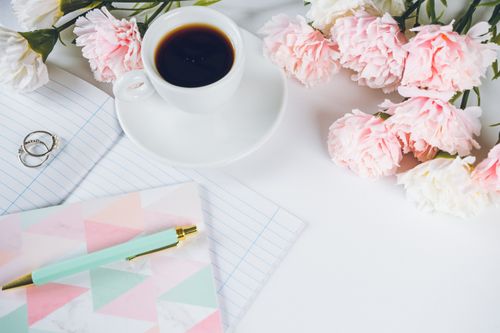 Free A stylish flat lay with coffee, peonies, notebook, and pen on a white desk. Stock Photo