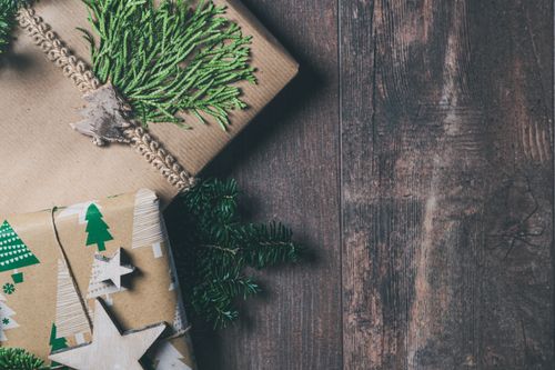 Free Beautifully wrapped Christmas gifts with natural elements and rustic decor on wooden background. Stock Photo
