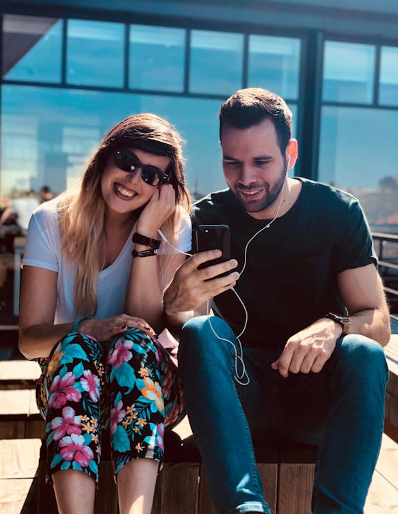 Free Man and Woman Using an Earphones Stock Photo