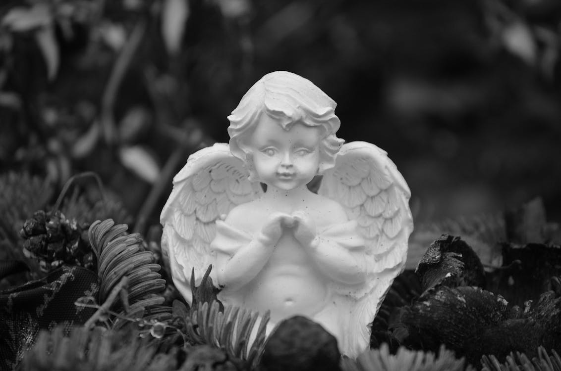 Grayscale Photo of an Angel Ceramic Figurine · Free Stock Photo