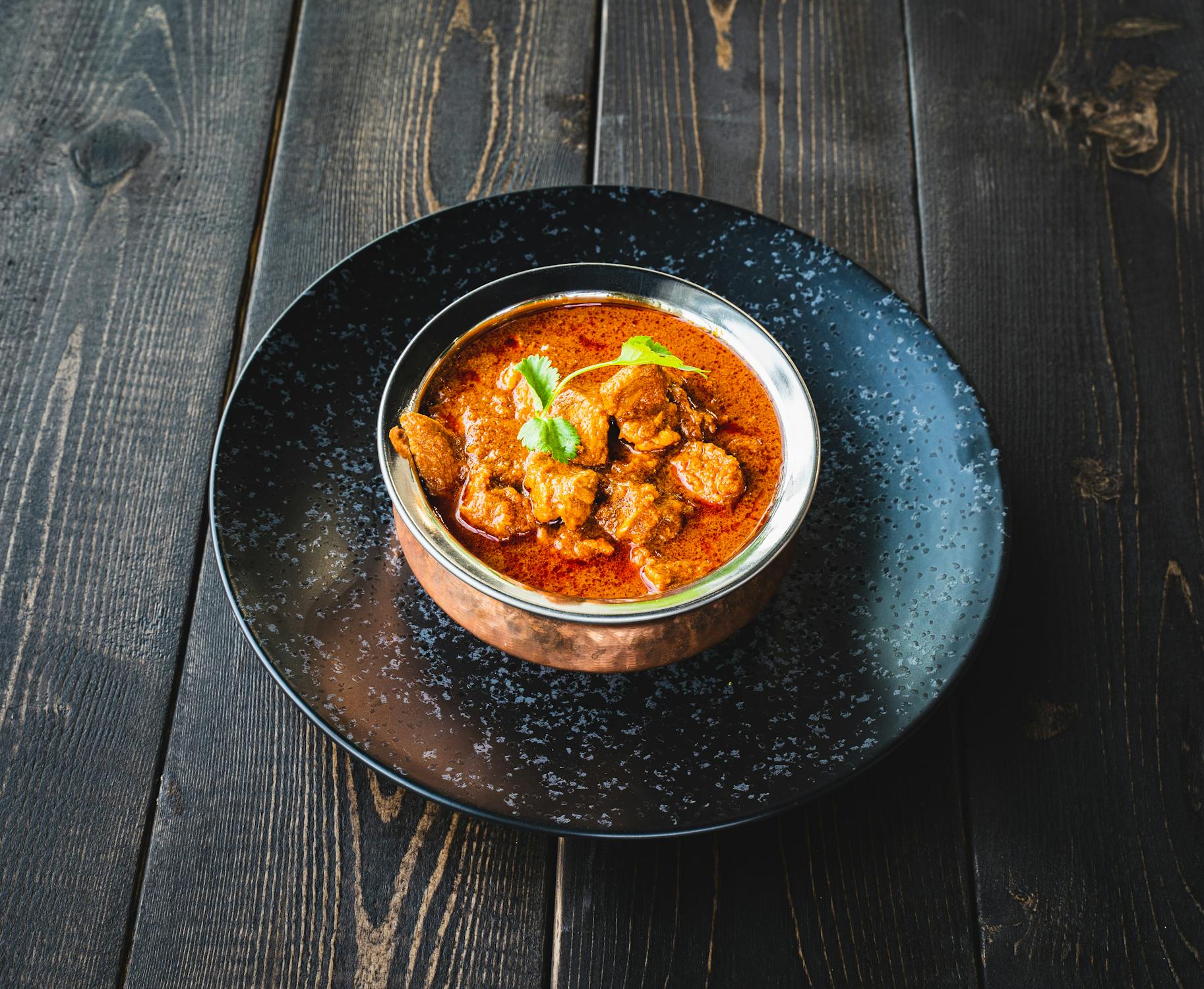 A Bowl of Curry on a Wooden Surface