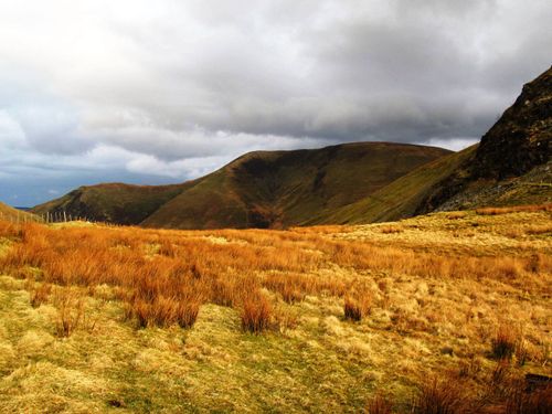 Free Stunning view of the Welsh countryside with autumn hues and rolling hills under a cloudy sky. Stock Photo