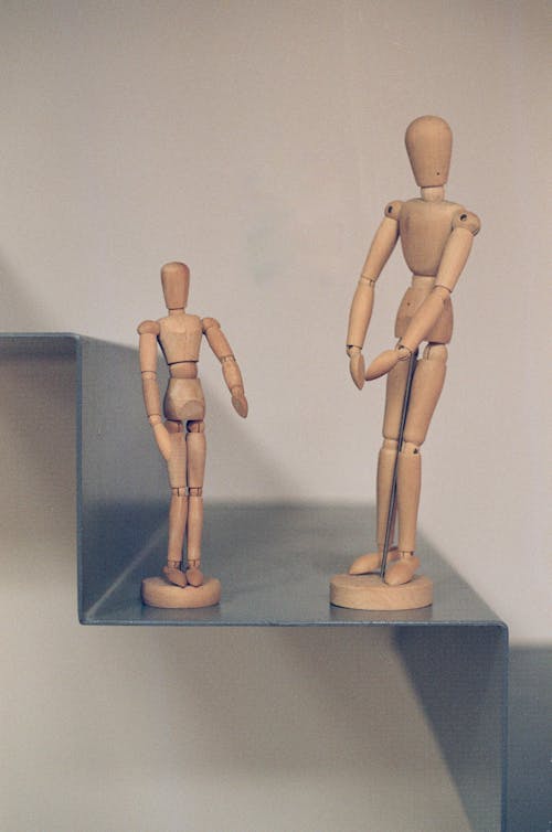 A Close-Up Shot of Wooden Human Figurines