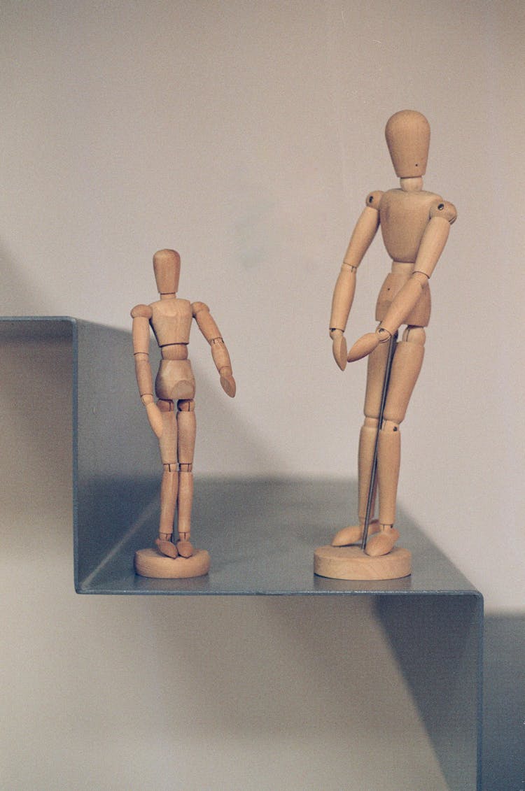 A Close-Up Shot Of Wooden Human Figurines