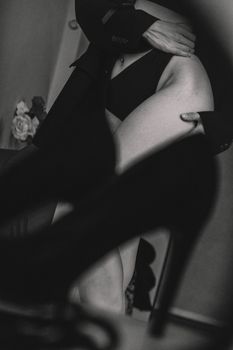 Stylish black and white photo of a woman in lingerie with heels, capturing elegance.