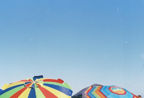 Colorful Beach Umbrellas under Blue Sky