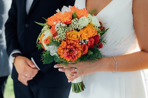 A Close-Up Shot of a Woman Holding a Bridal Bouquet