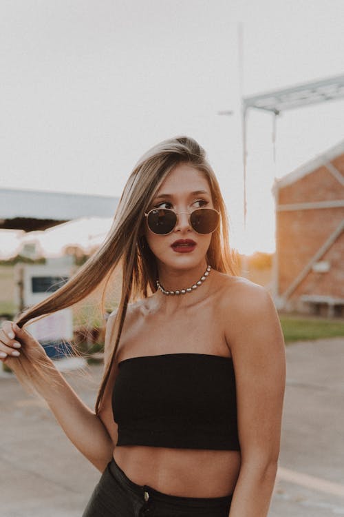 Woman in Black Tube Top with Hand on Hair