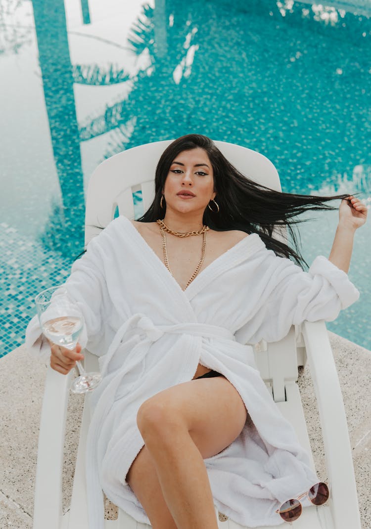 Woman In White Robe Sitting On A Chair