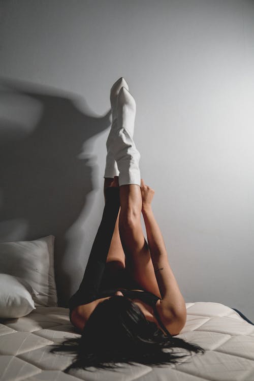 Free Woman Lying on a Bed Stock Photo