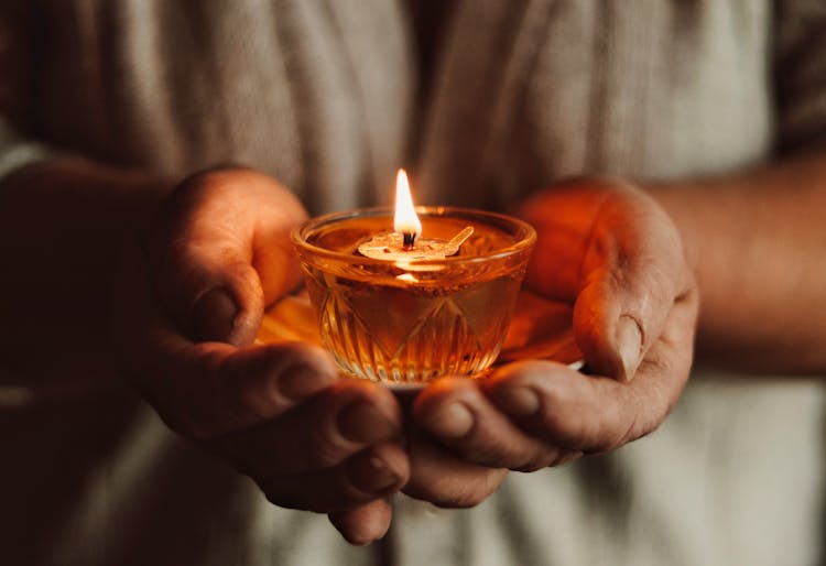 A Person Holding A Candle