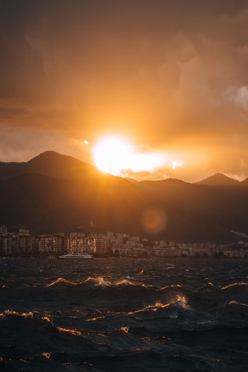 Free Breathtaking sunset view over İzmir's coast, highlighting mountains and sea. Stock Photo