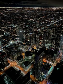 Stunning aerial view of Toronto's illuminated skyline at night, showcasing urban life.