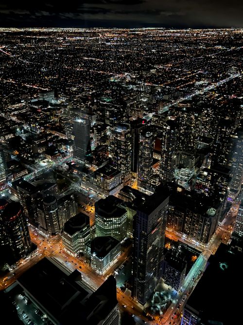 Free Stunning aerial view of Toronto's illuminated skyline at night, showcasing urban life. Stock Photo