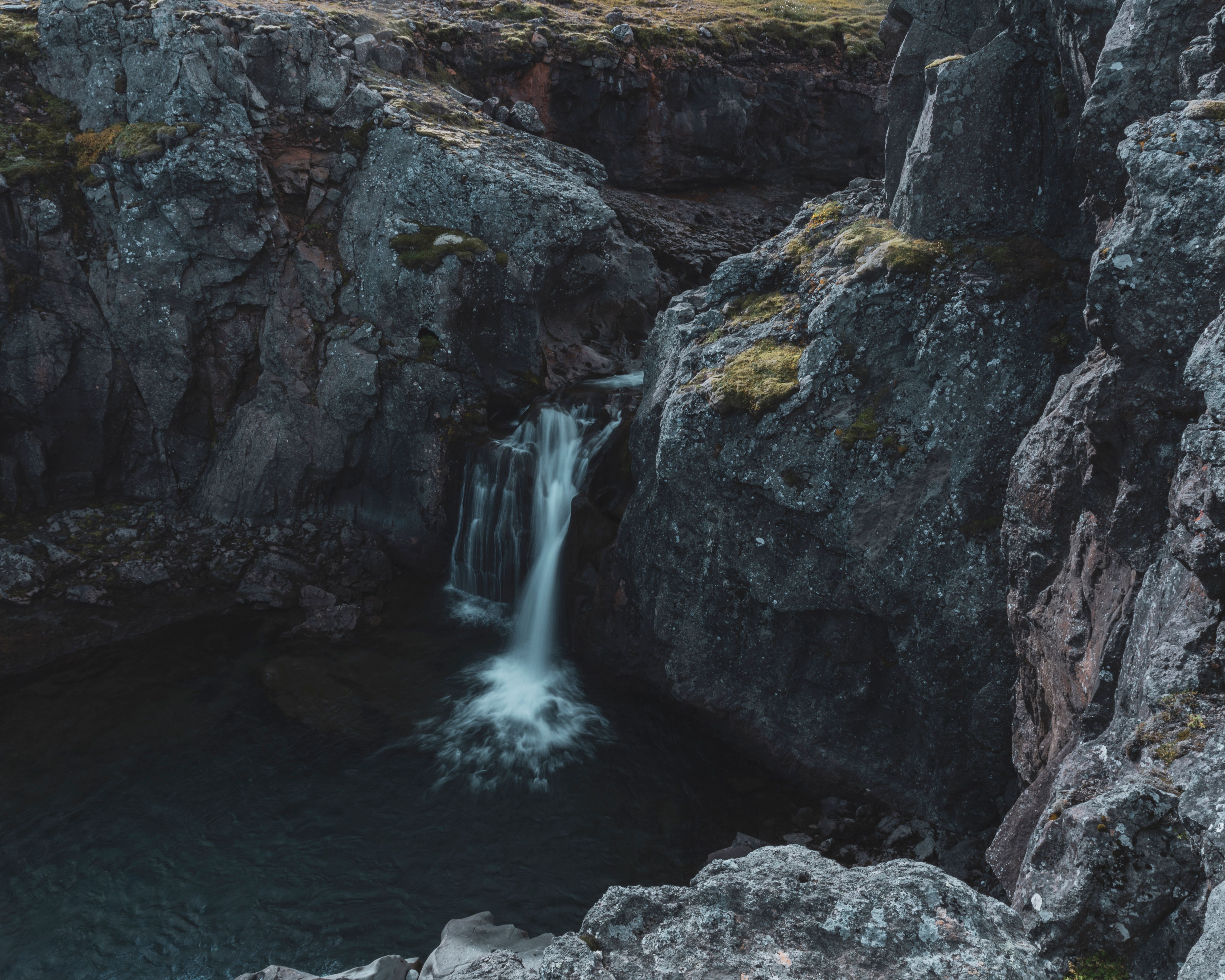 A Waterfall Flowing from a Rock Formation · Free Stock Photo