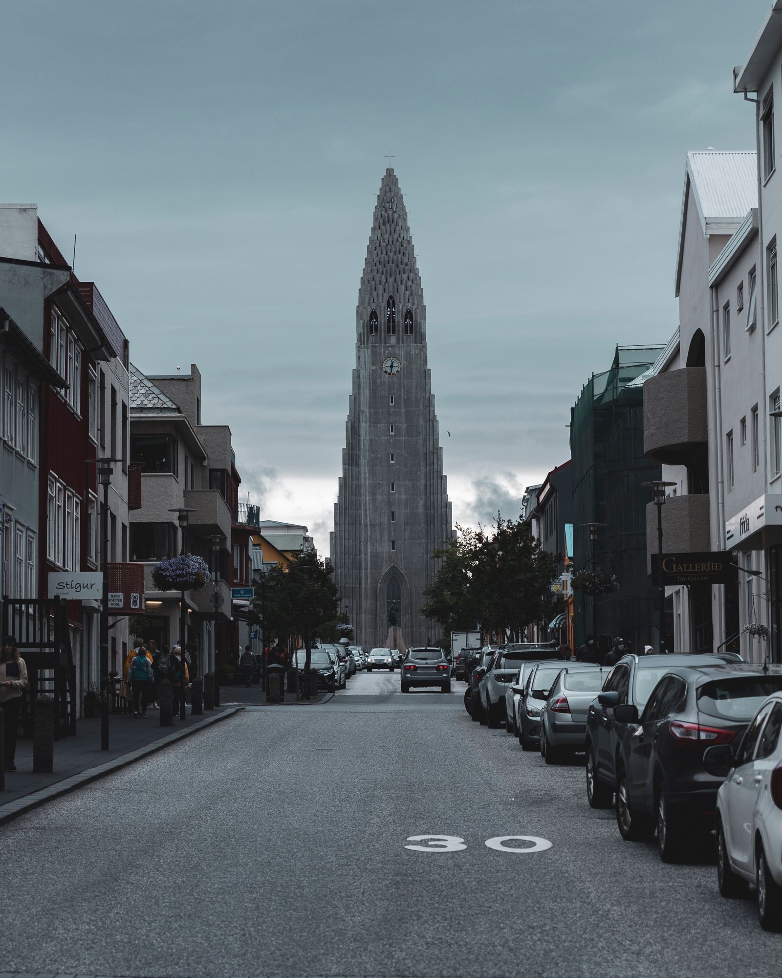 Hallgrímskirkja church rising at the end of a quiet Reykjavík street lined with houses