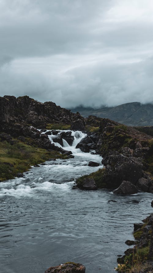 Creek on Rocky Mountain Under White Clouds