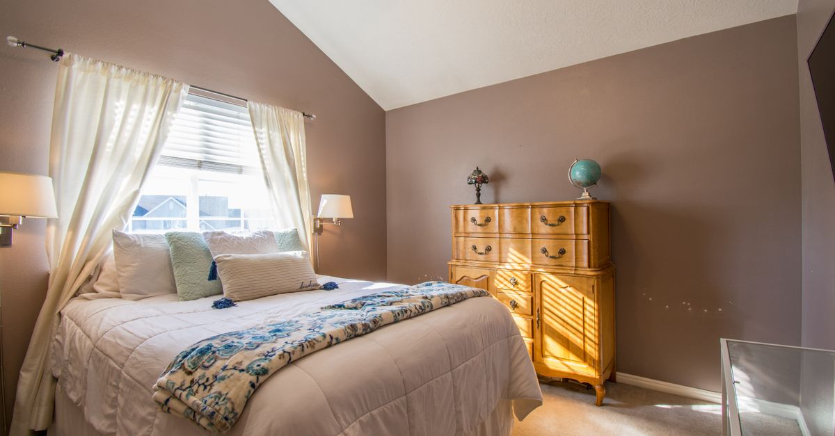 Bright and inviting bedroom interior with neutral tones and elegant decor.