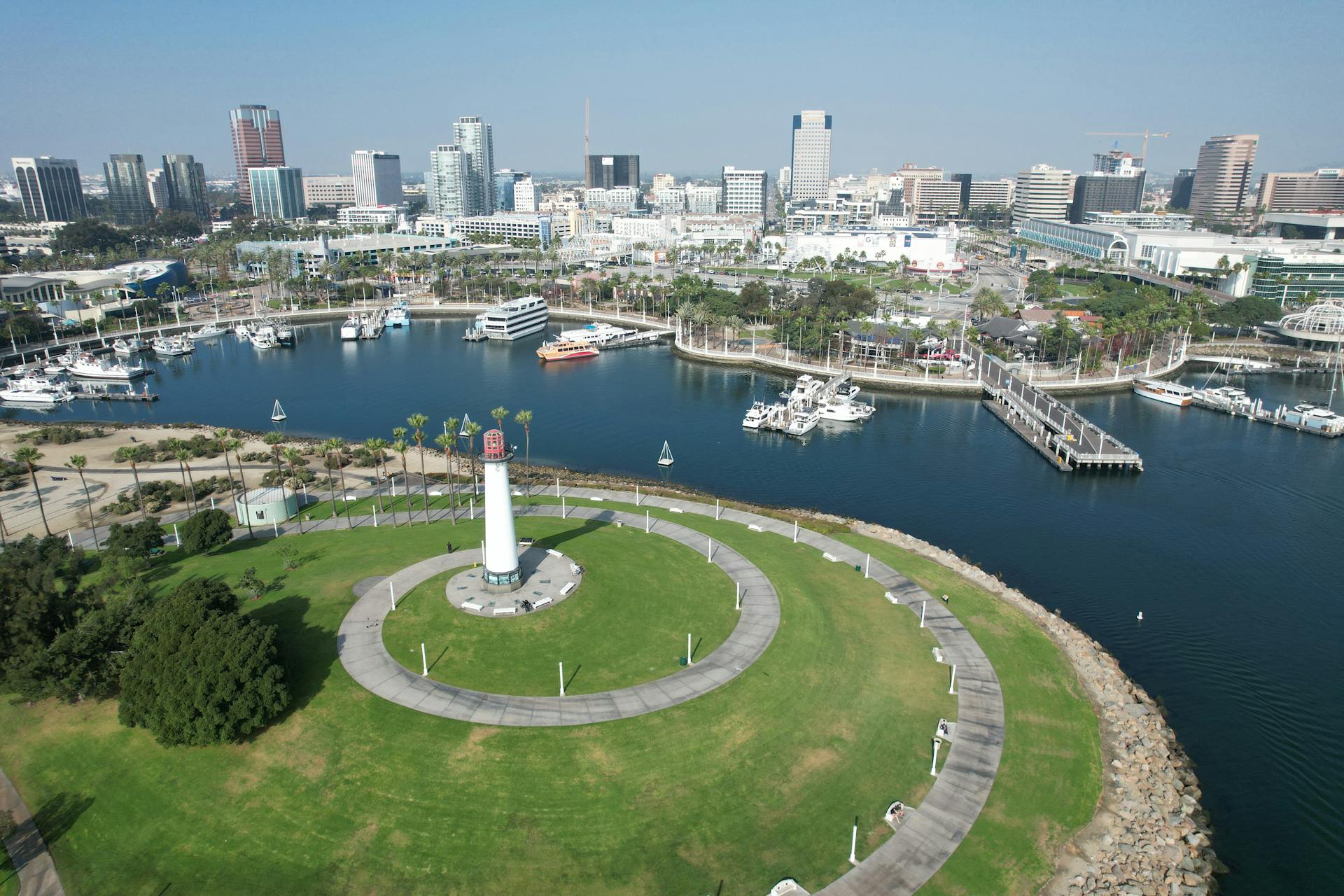 A stunning aerial shot of Long Beach, CA, featuring the skyline, marina, and iconic lighthouse.