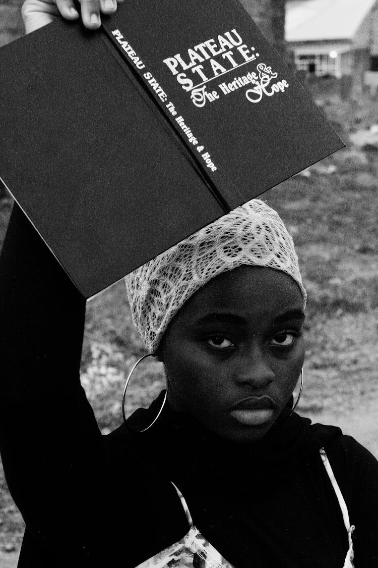 Black And White Photo Of A Girl Holding A Book