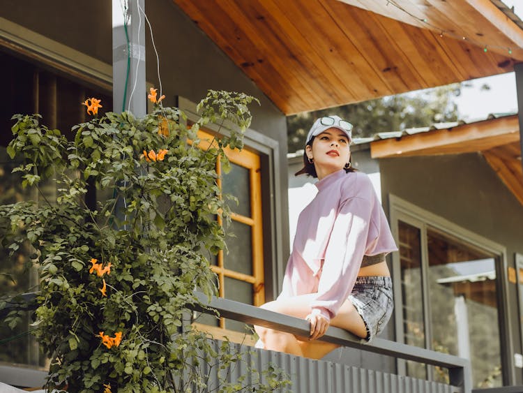 Young Woman Sitting On A Porch 