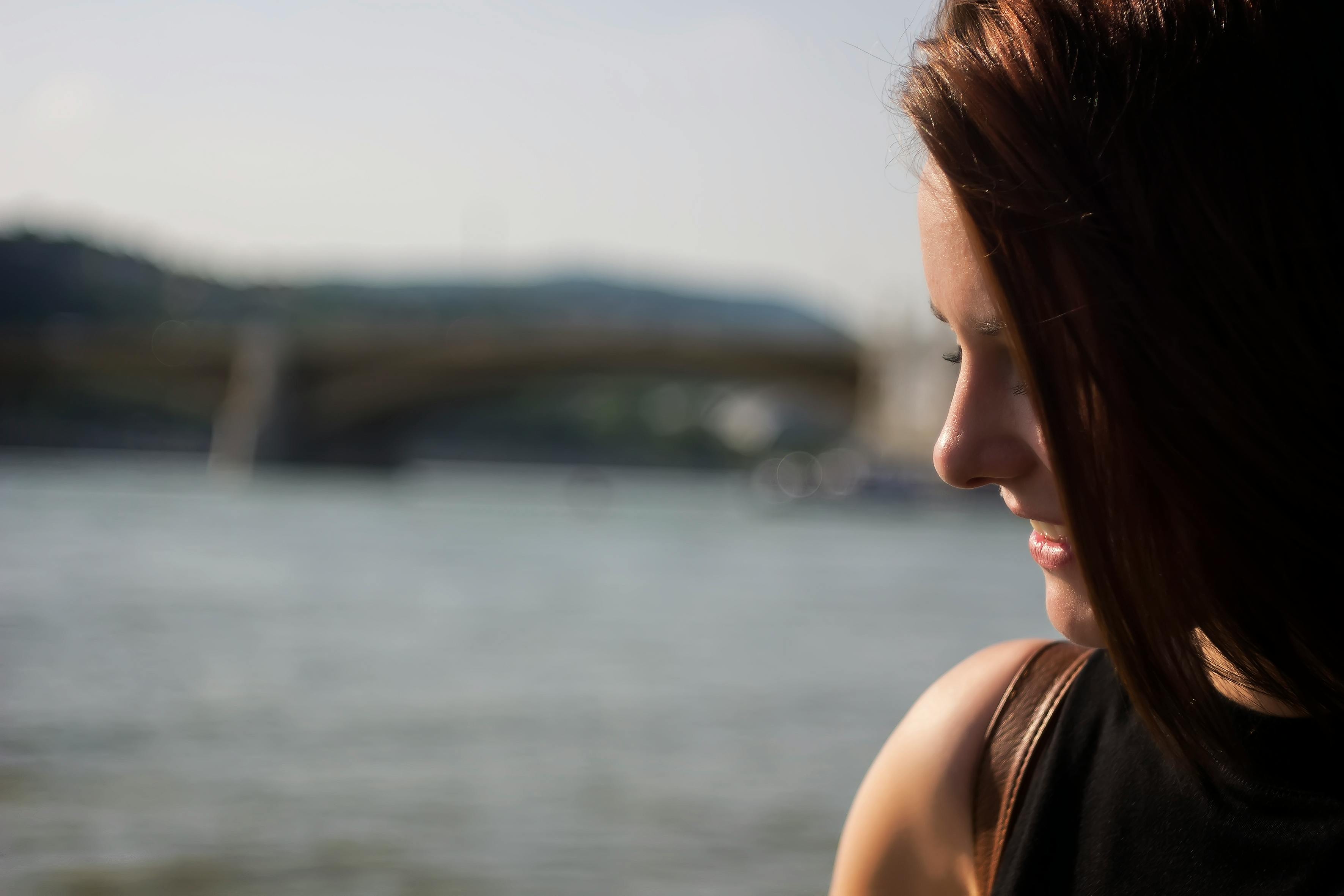 Close Up Photography of Side View Angle of a Woman Smiling Near Seawater during Daytime · Free Stock Photo