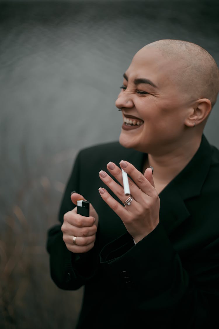 Woman In Black Long Sleeves Holding A Cigarette And Lighter