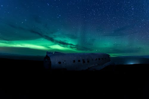 An Airplane in Ruins Under Green and Blue Sky