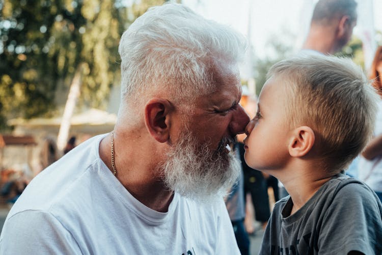 Elderly Man And A Boy Facing Each Other