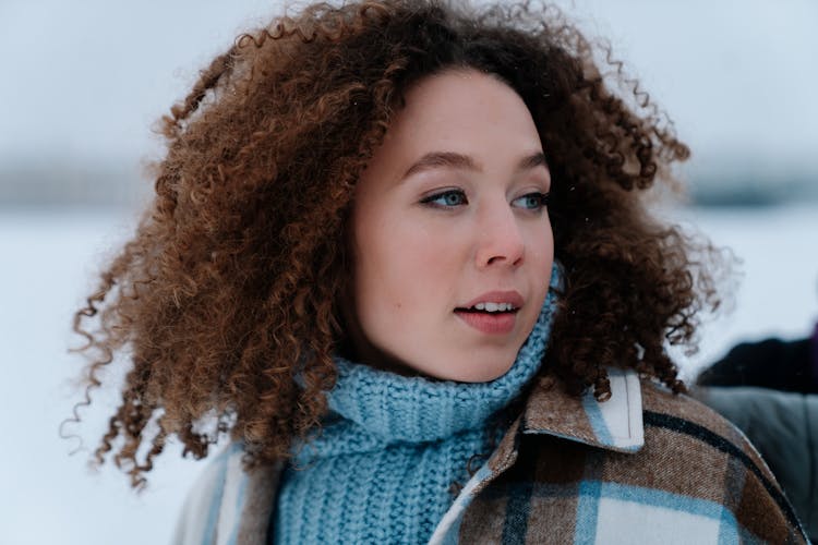 Portrait Of Woman With Curly Hair Wearing Winter Clothes