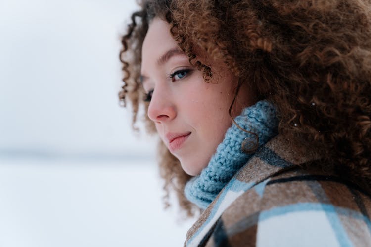 Portrait Of Woman With Curly Hair Wearing Winter Clothes