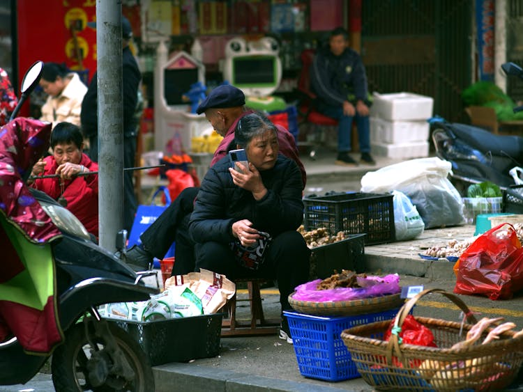 A Woman Selling Goods In The Market