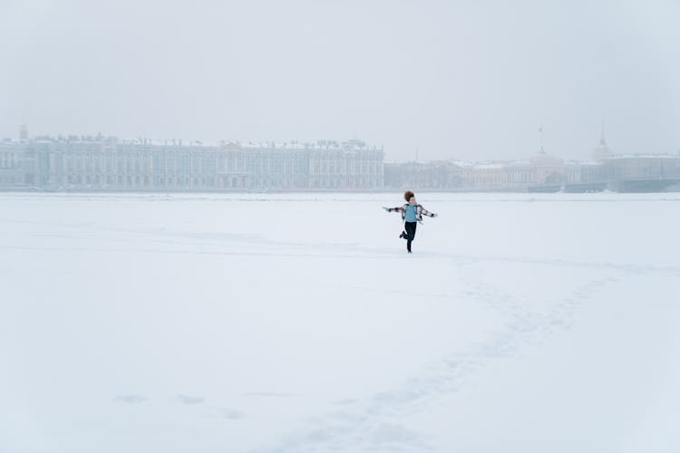 Curly Haired Woman Running In Snow