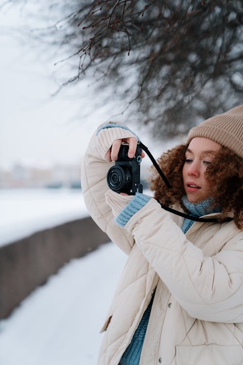 Portrait of Curly Haired Woman Taking Photo