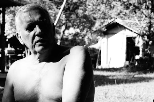 Grayscale Photo of a Topless Elderly Man
