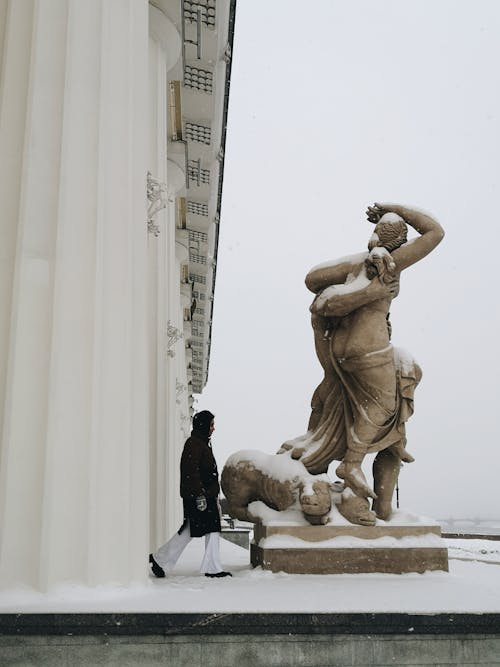 Woman Next to Renaissance Sculpture