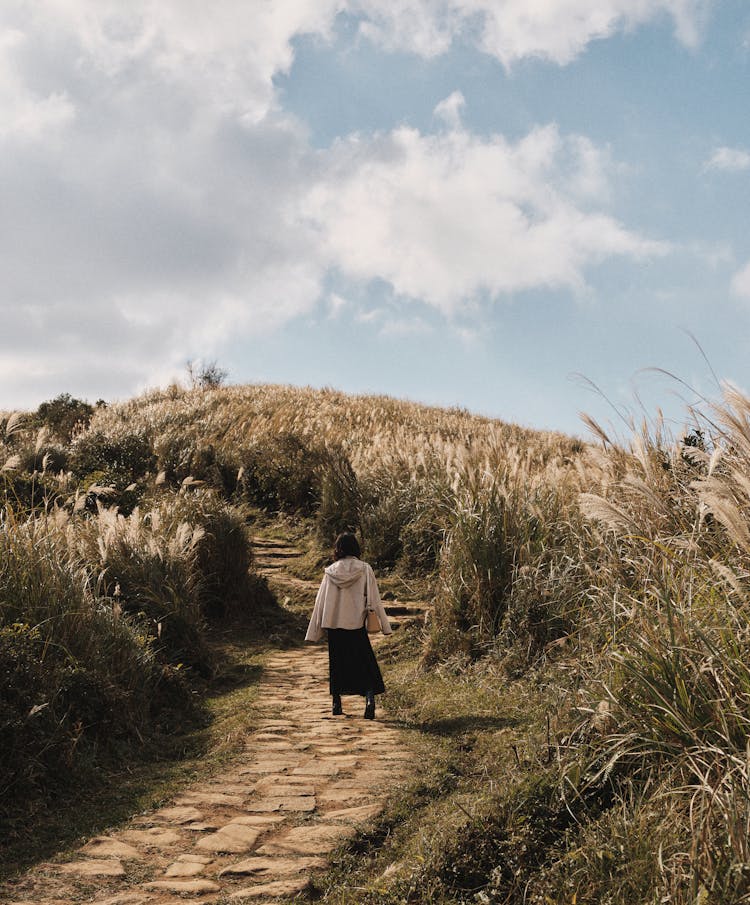 Woman Walking On Pathway