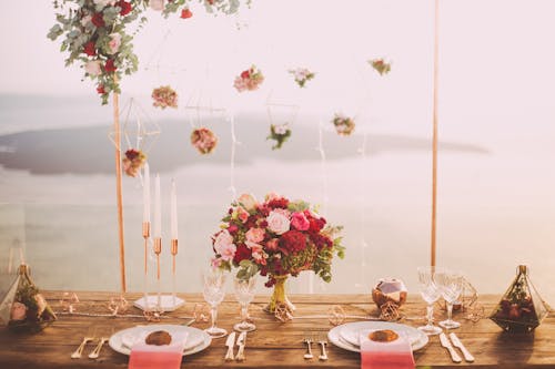 Free Pink and Red Roses Centerpiece Near Silverwares Stock Photo