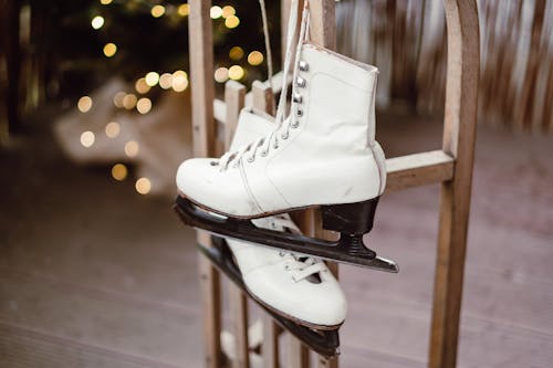White Leather High Top Sneakers on Black Metal Rack