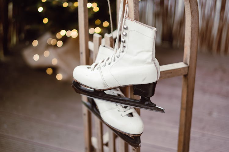 Ice Skating Shoes Hanging On A Wooden Rack