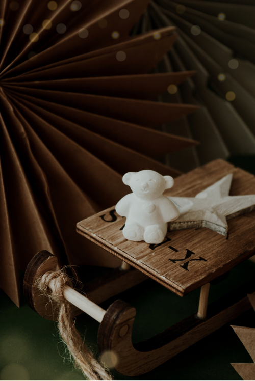 Free A charming wooden sled with a plaster teddy bear and star, evoking a cozy winter feel. Stock Photo