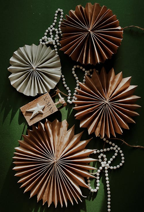 Paper Wheel Fans and a String of Beads on a Green Surface